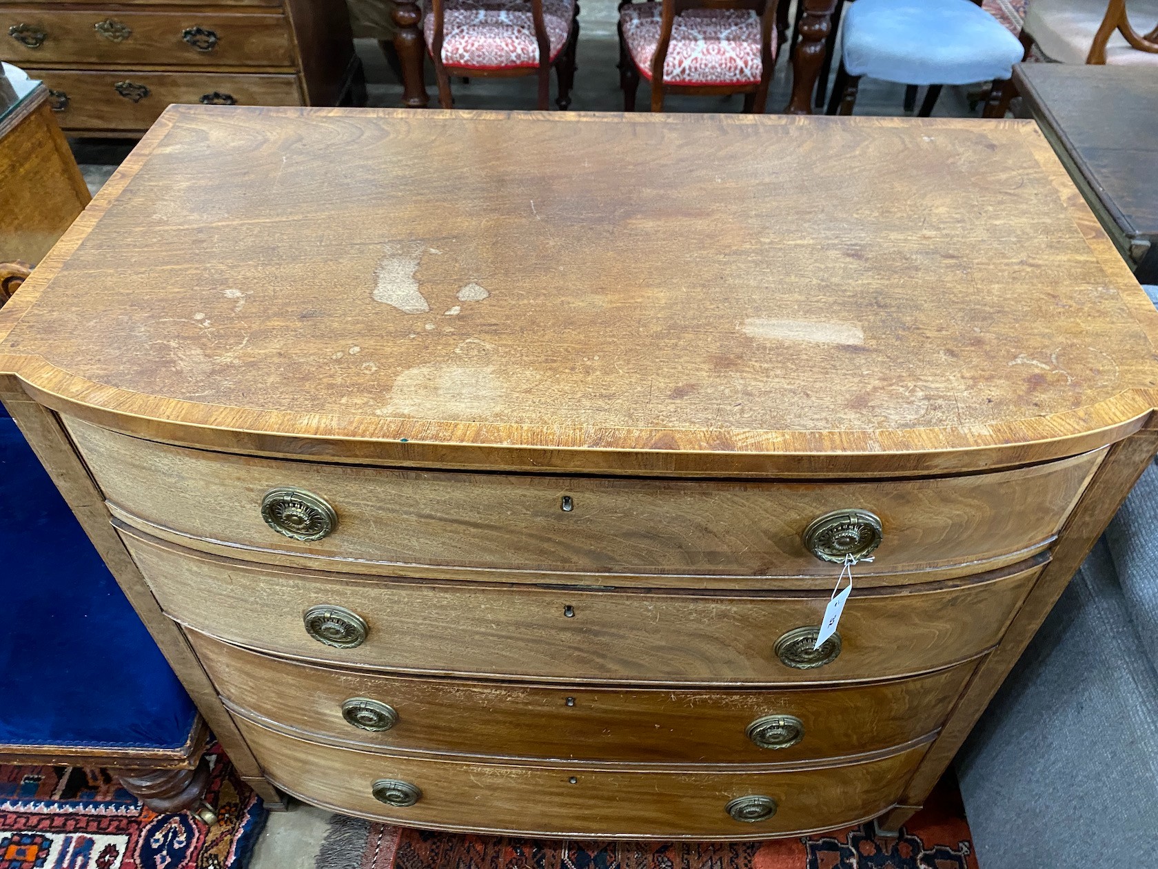 A Regency banded faded mahogany bowfront chest of four graduated long drawers, width 108cm, depth 58cm, height 100cm